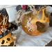 This shows the side of the pumpkin gourd that has a scar carved into the shell. The scar is stitched up with a hemp cord.